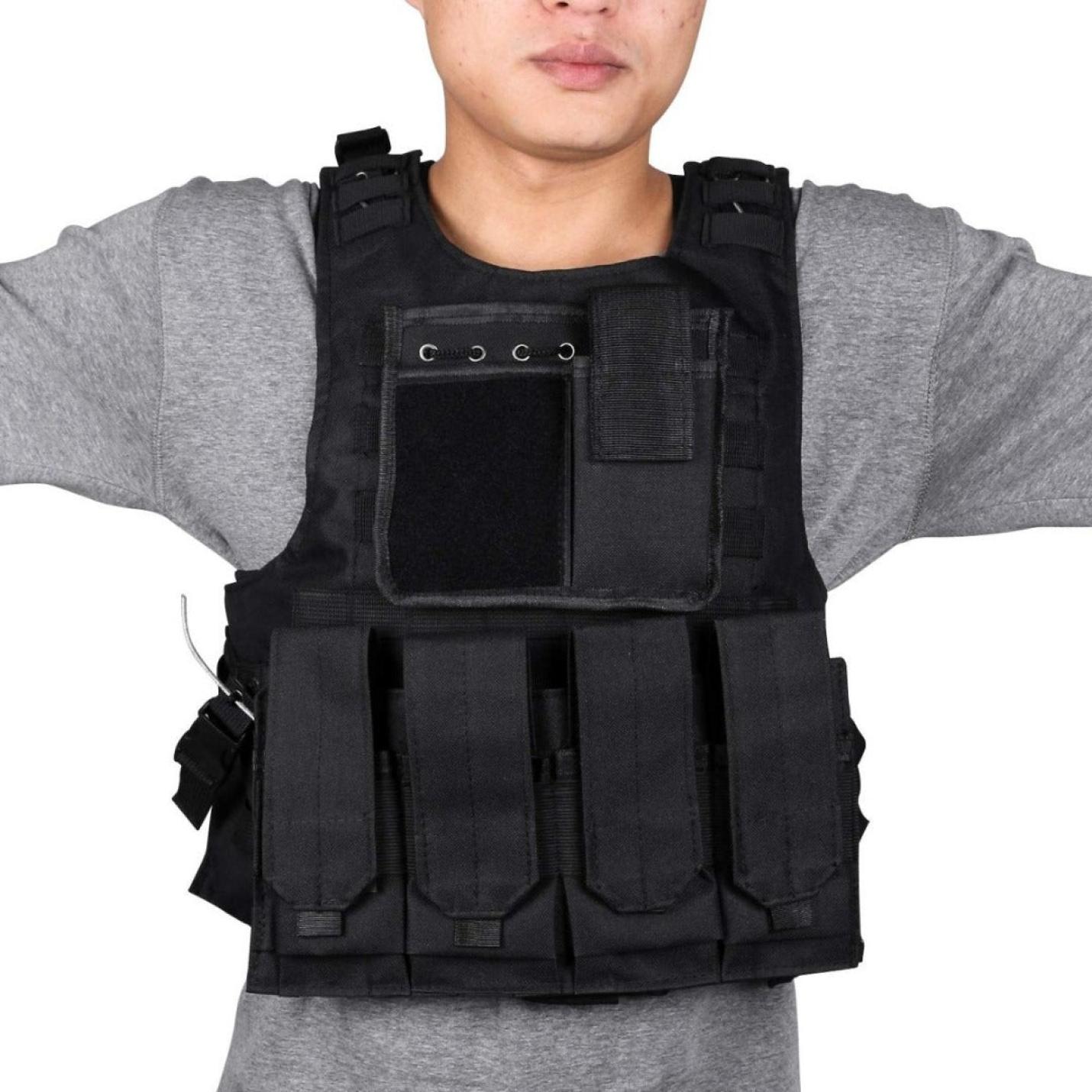 Persoon die een ontketen draagt, je ware potentieel met het verstelbare tactische vest voor paintball met meerdere zakjes over een grijs shirt, geïsoleerd op een witte achtergrond.