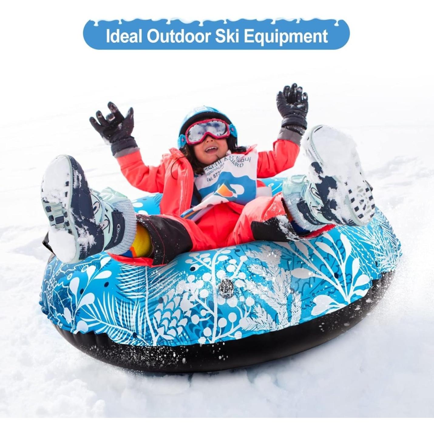 Kind in kleurrijk sneeuwpak en skibril glijdt vrolijk van een besneeuwde heuvel af in een blauw patroon Gaan voor de rit van je leven met deze opblaasbare slee, onder de tekst "ideale outdoor ski-uitrusting".